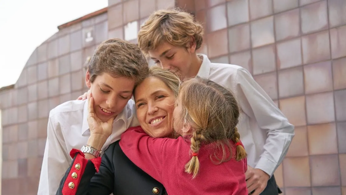 Una madre abrazada por sus tres hijos, una imagen sobre el precio del seguro de decesos en Navarra